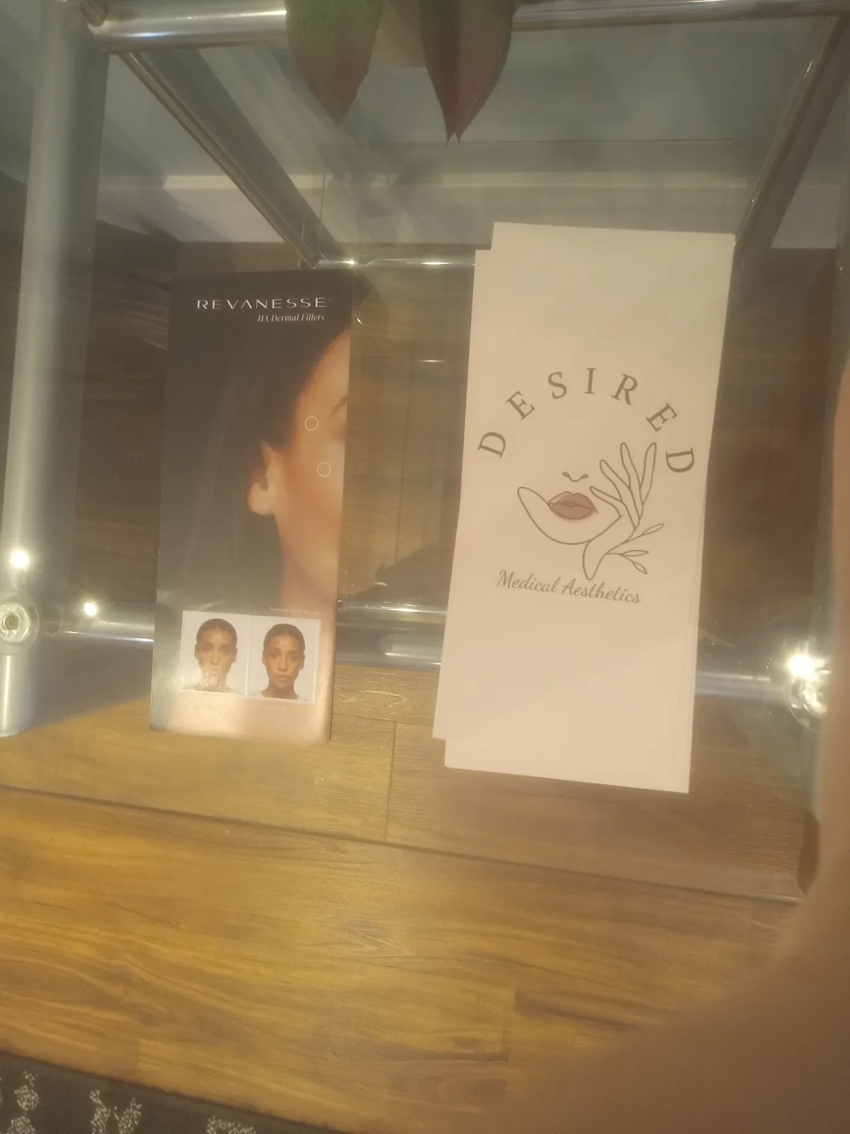 Desired Medical Aesthetics cards and display on a counter inside Renew You