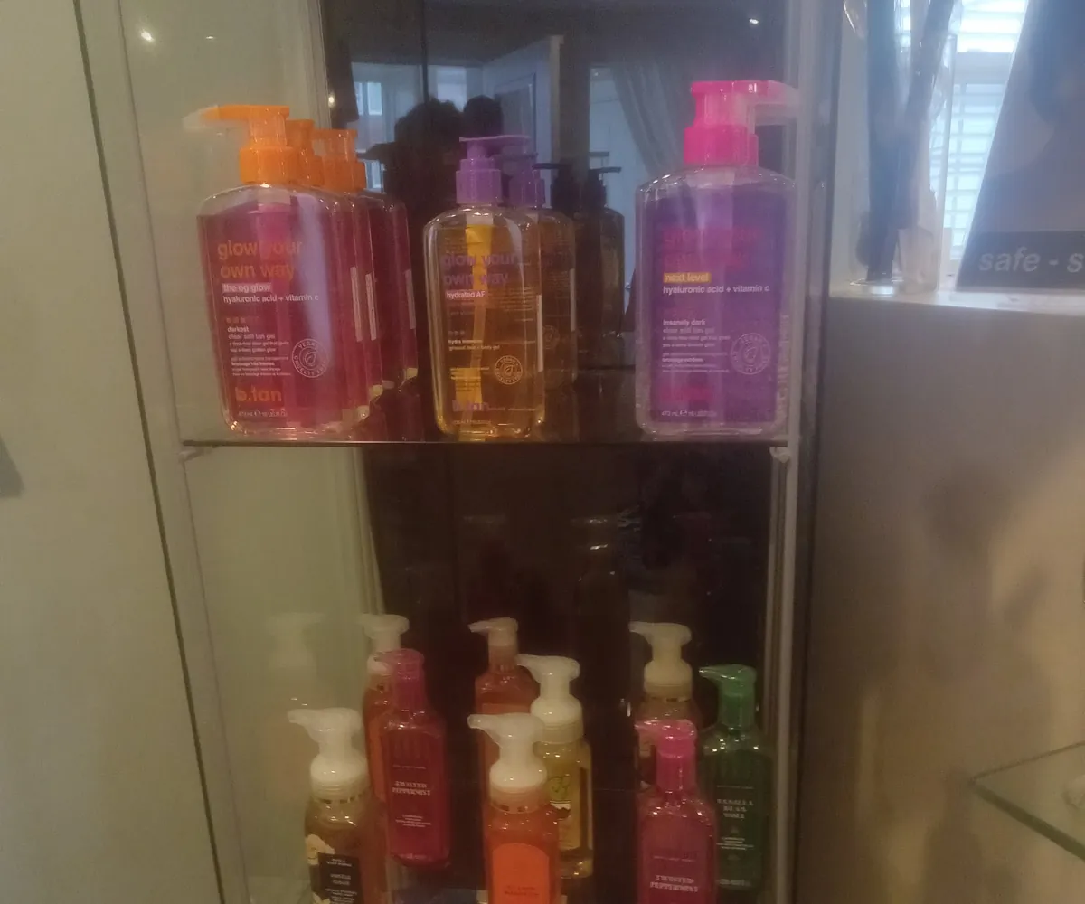 Colourful Hempz and body-care bottles in a salon display case